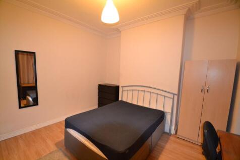 A cozy bedroom featuring a comfortable bed, a w...