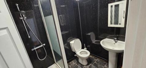 A compact, well-maintained bathroom featuring a...