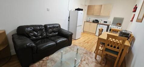 A cozy living room with a comfortable black lea...