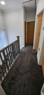 Bright first-floor landing with carpeted floors...