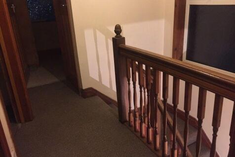 Well-maintained upstairs landing with wooden ba...