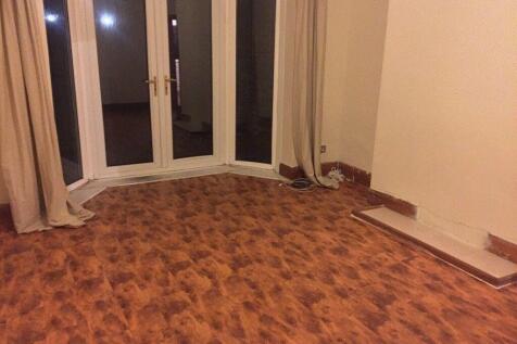 Bright living room with full-height patio doors...