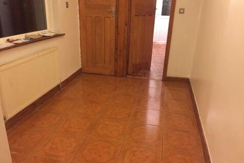 Bright, clean hallway with tiled flooring, timb...
