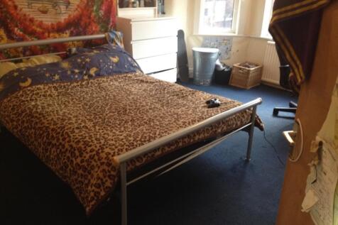 A cozy master bedroom featuring a double bed wi...