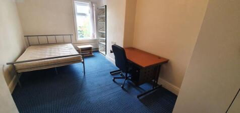 A neatly arranged double bedroom featuring a me...