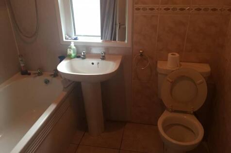 A functional bathroom suite featuring a bathtub...