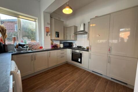Bright, modern kitchen with glossy fitted cabin...