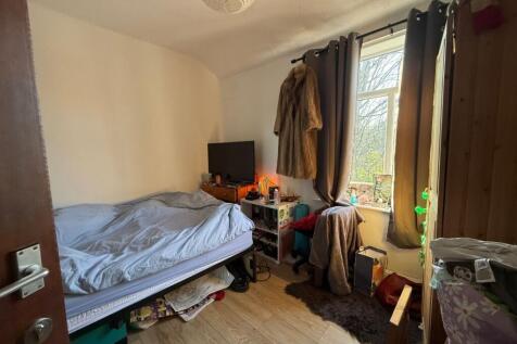 Well-lit double bedroom with a comfy bed, bedsi...