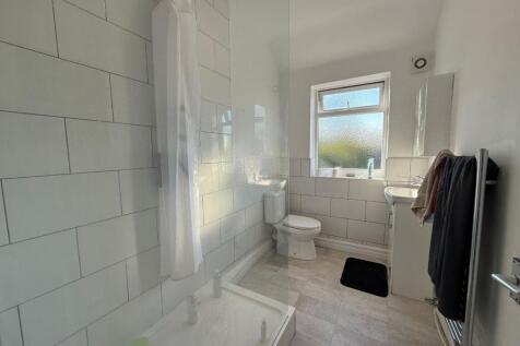 Bright, modern bathroom with white subway tiles...