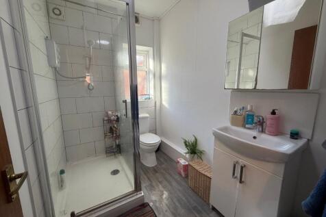 Bright, modern bathroom with a corner shower cu...