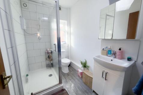 Bright, modern bathroom with a walk-in shower, ...