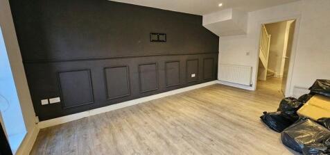 A spacious living room featuring modern wood-ef...