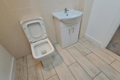 Bright and clean single toilet area featuring m...