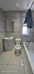 A modern and tidy bathroom featuring a sleek wh...