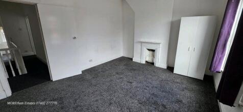 A well-lit double bedroom featuring a neutral c...