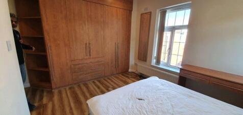 Bright bedroom with large fitted wardrobes, woo...