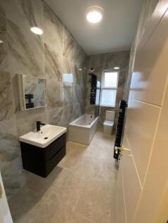 Modern, well-maintained bathroom featuring a sl...
