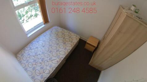 A small, clean restroom with basic fixtures, of...