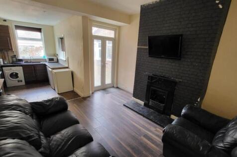 A spacious and inviting living room featuring m...