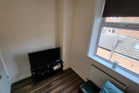 A cozy bedroom featuring a window that allows n...