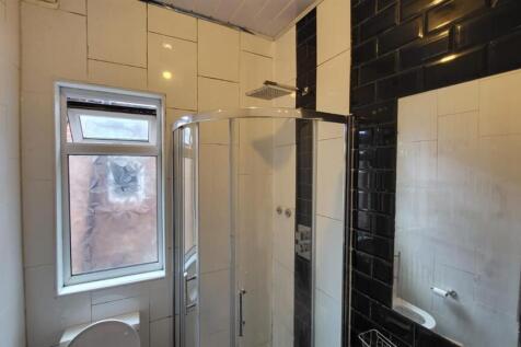 A clean and modern bathroom with a large shower...