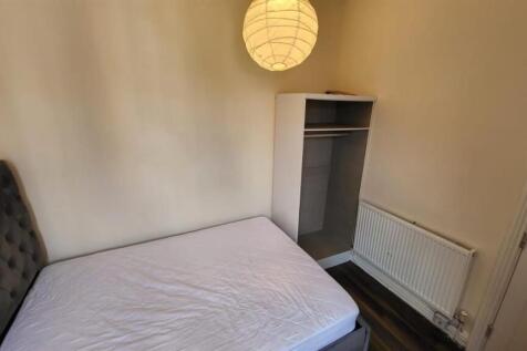 A small, tidy toilet room with basic fixtures, ...