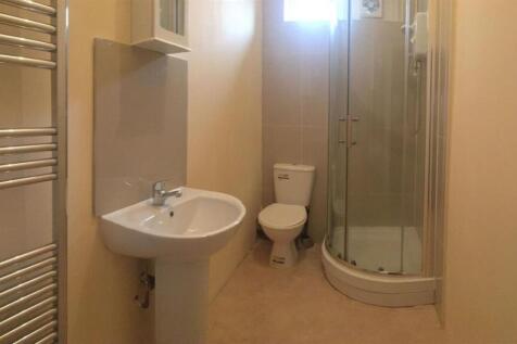 Bright, modern bathroom with a pedestal sink, c...