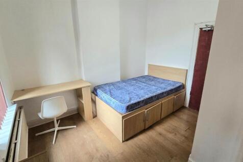 Bright, simply furnished bedroom with a raised ...