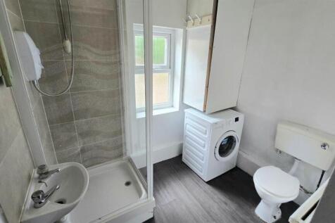 Bright, tidy bathroom with a modern shower encl...