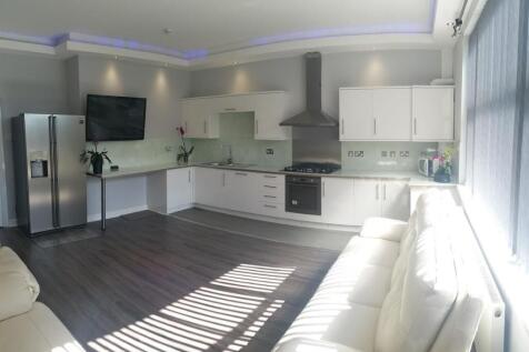 Bright, modern open-plan living area with a sle...