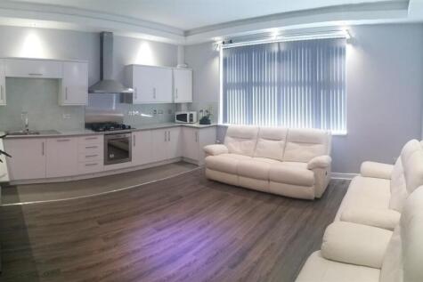 Bright, modern open-plan living area with a sle...