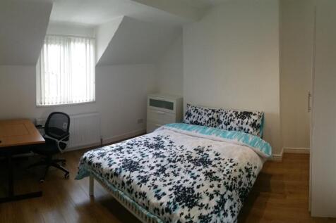 Bright, simply furnished bedroom with a pattern...