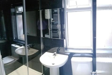 Bright, modern bathroom with a pedestal sink, t...