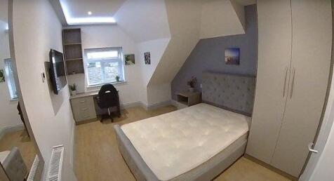 Bright, modern double bedroom with a comfortabl...