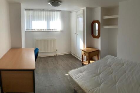 Bright, simply furnished bedroom with a double ...