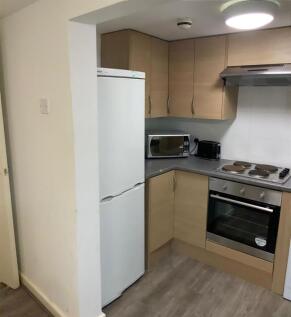 Compact modern kitchenette with integrated oven...