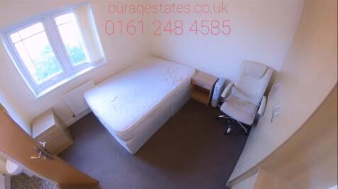 Bright, simply furnished bedroom with a comfort...