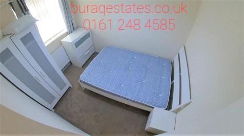 Bright, simply furnished bedroom with a double ...