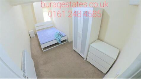 Bright, simply furnished bedroom with a single ...
