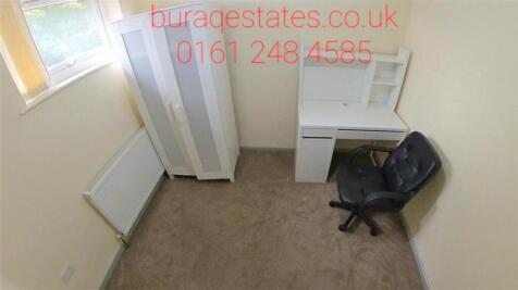 Compact, tidy bedroom with a wardrobe, desk and...