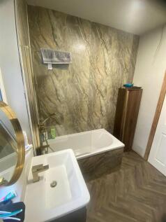 Contemporary bathroom with a sleek bathtub set ...