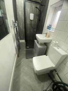 Modern bathroom with a walk-in shower, compact ...