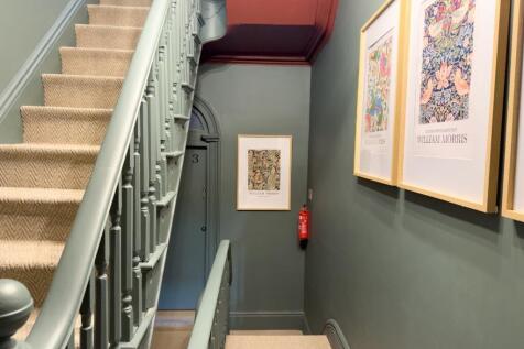 Well-kept interior staircase with carpeted step...