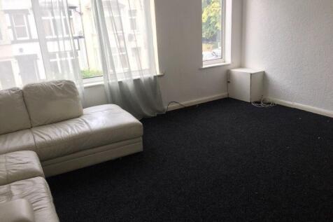 Bright living room with large street-facing win...