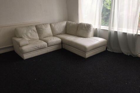 Bright corner living room with a large L-shaped...