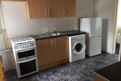 Neat fitted kitchen with matching wood-effect c...