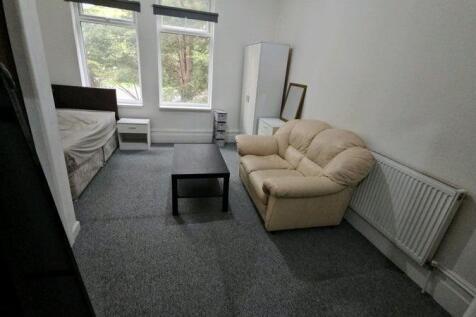 Bright furnished bedroom with two large windows...