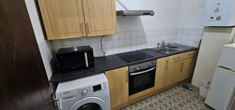 Compact fitted kitchen with integrated oven and...