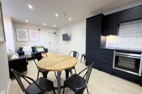 Modern open-plan living area with a round dinin...