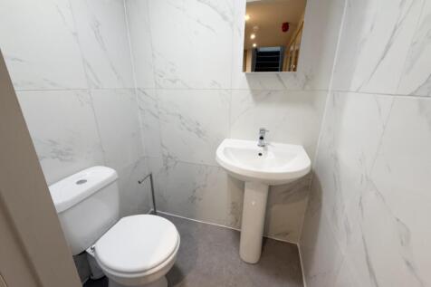 Bright, modern WC with white sanitaryware and c...